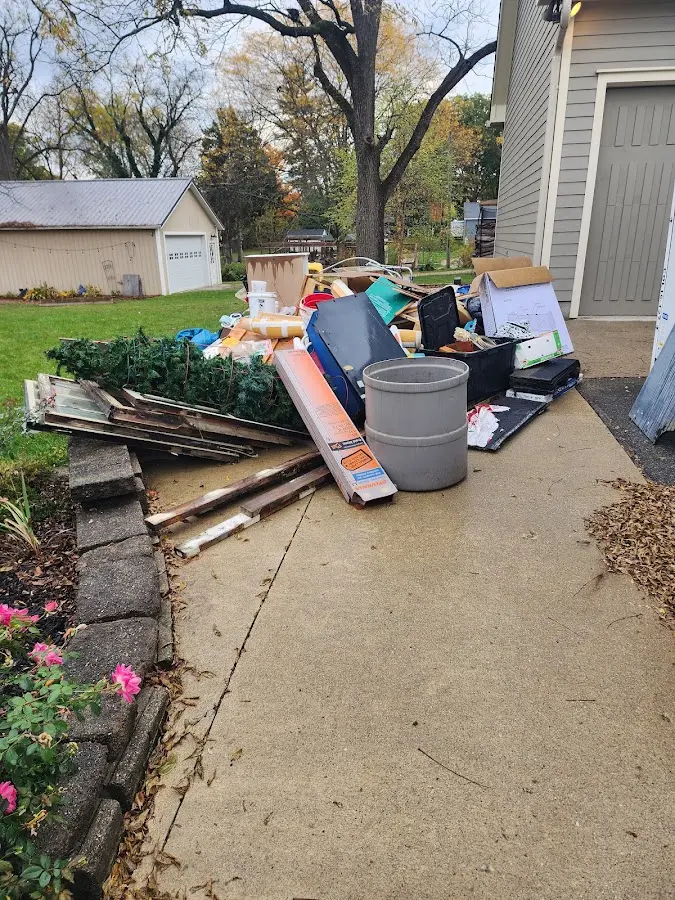Dumpster being loaded with debris for 12 Yard Dumpster Rental in Hudson Falls